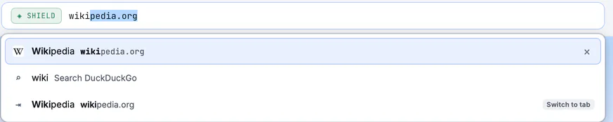 The address bar with its list open: Wikipedia from the history, a search, and a switch to the open tab.